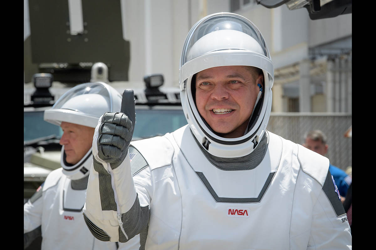 NASA astronauts Robert Behnken, foreground, and Douglas Hurley, wearing SpaceX spacesuits, are seen as they depart the Neil A. Armstrong Operations and Checkout Building for Launch Complex 39A to board the SpaceX Crew Dragon spacecraft for the Demo-2 mission launch, Saturday, May 30, 2020, at NASA’s Kennedy Space Center in Florida. (NASA/Bill Ingalls)