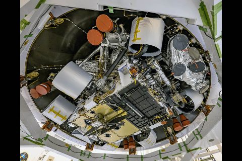 NASA's Mars Perseverance rover's descent stage was recently stacked atop the rover at Kennedy Space Center, and the two were placed in their back shell. The Ingenuity helicopter can be seen attached to the rover's underside (lower center of the image). (NASA/JPL-Caltech) NASA's Mars Perseverance rover's descent stage was recently stacked atop the rover at Kennedy Space Center, and the two were placed in their back shell. The Ingenuity helicopter can be seen attached to the rover's underside (lower center of the image). (NASA/JPL-Caltech)