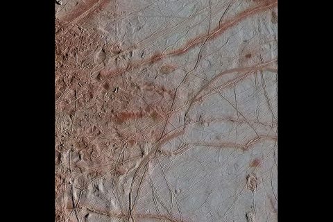 In this gallery of three newly reprocessed Europa images, details are visible in the variety of features on the moon's icy surface. This image of an area called Chaos Transition shows blocks that have moved and ridges possibly related to how the crust fractures from the force of Jupiter's gravity. (NASA/JPL-Caltech/SETI Institute)