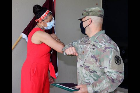 Blanchfield Army Community Hospital Logistics Division Chief, Maj. Bryan Stewart offers a congratulatory elbow bump to BACH Supply Technician, Ms. Willie Mae Guidry, after a ceremony naming her Regional Health Command Atlantic Civilian of the Year, Category 1. (U.S. Army photo by Maria Yager)