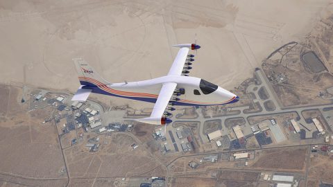 This artist’s concept image shows NASA’s first all-electric X-plane, the X-57 Maxwell, in its final configuration, flying in cruise mode over NASA’s Armstrong Flight Research Center in Edwards, California. In Mod IV test flights, X-57’s high-lift motors will deactivate during cruise mode, and their propeller blades will fold in to the nacelles to reduce drag. (NASA Langley/Advanced Concepts Lab, AMA, Inc)