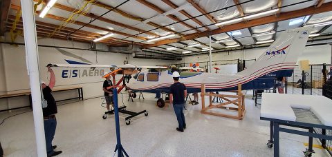 Engineers at Empirical Systems Aerospace, or ESAero, perform fit checks on the future wing to be used on the final configurations of NASA’s all-electric X-57 Maxwell, at their facility in San Luis Obispo, California. Using a “fit check” fuselage, seen here, the team is able to determine the safest and most efficient method of integrating the wing to be used in Mods III and IV of X-57, while the primary fuselage prepares for ground, taxi, and flight tests at NASA’s Armstrong Flight Research Center in Edwards, California. (Empirical Systems Aerospace)