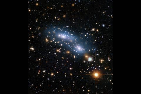 This image from the NASA/ESA Hubble Space Telescope shows the galaxy cluster MACS J0416. This is one of six galaxy clusters being studied by the Hubble Frontier Fields program, which produced the deepest images of gravitational lensing ever made. Scientists used intracluster light (visible in blue) to study the distribution of dark matter within the cluster. (NASA, ESA and M. Montes (University of New South Wales))