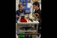 Annie Meier, left, and Jamie Toro assemble the flight hardware for the Orbital Syngas/Commodity Augmentation Reactor (OSCAR) in the Space Station Processing Facility at NASA’s Kennedy Space Center in Florida. (NASA/Cory Huston)