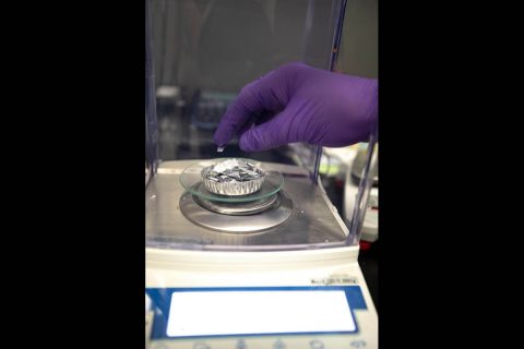 Weighing in waste. A trash simulant, a mix of different types of material cut into tiny pieces, is weighed on a scale for use in OSCAR. (NASA/Frank Michaux)