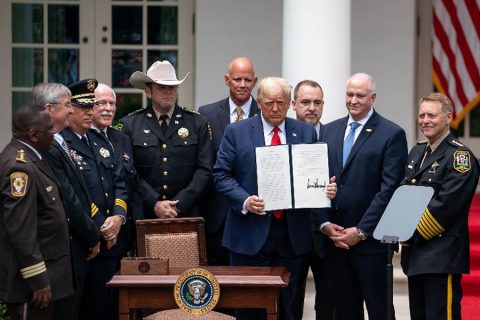 President Donald Trump signs an executive order on safe policing for safe communities. (White House)