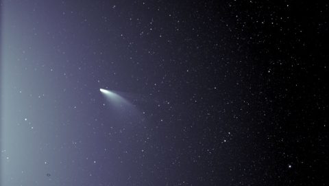 An unprocessed image from the WISPR instrument on board NASA’s Parker Solar Probe shows comet NEOWISE on July 5, 2020, shortly after its closest approach to the Sun. The Sun is out of frame to the left. The faint grid pattern near the center of the image is an artifact of the way the image is created. The small black structure near the lower left of the image is caused by a grain of dust resting on the imager’s lens. (NASA/Johns Hopkins APL/Naval Research Lab/Parker Solar Probe/Brendan Gallagher)