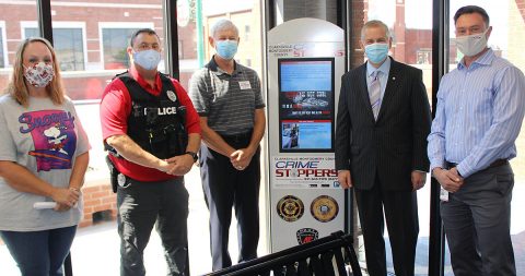 Clarksville Crime Stoppers has installed its first information kiosks at the Transit Center on Legion Street to aid the organization’s outreach to the community. The group plans to add  more kiosks at the County Courts Center, at APSU and at two Walmarts. Joining in the unveiling of the kiosk, from left, are Crime Stoppers Treasurer Deanna McLaughlin, CPD Officer Roger Carroll, Crime Stoppers President Bill Summers, Clarksville Mayor Joe Pitts and CTS Director Paul Nelson.