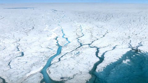 This aerial photograph shows fast-moving meltwater rivers flowing across the Greenland Ice Sheet, a region that, combined with Antarctic meltwater and thermal expansion, accounts for two-thirds of observed global mean sea level rise. (NASA)