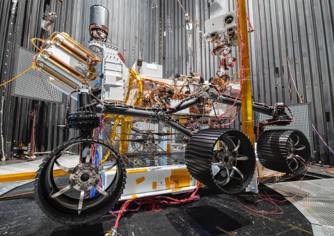 The NASA Ingenuity Mars Helicopter can be seen between the left and center wheels of the Mars 2020 Perseverance rover. The image was taken in the vacuum chamber at JPL on October 1st, 2019. (NASA/JPL-Caltech) The NASA Ingenuity Mars Helicopter can be seen between the left and center wheels of the Mars 2020 Perseverance rover. The image was taken in the vacuum chamber at JPL on October 1st, 2019. (NASA/JPL-Caltech)