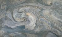 In the center of this JunoCam image, small, bright “pop-up” clouds seen rise above the surrounding features. Clouds like these are thought to be the tops of violent thunderstorms responsible for “shallow lighting.” (NASA/JPL-Caltech/SwRI/MSSS/Kevin M. Gill © CC BY)