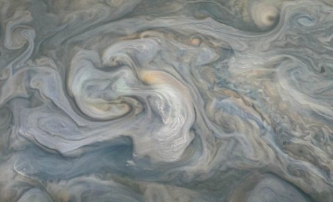 In the center of this JunoCam image, small, bright "pop-up" clouds seen rise above the surrounding features. Clouds like these are thought to be the tops of violent thunderstorms responsible for "shallow lighting." (NASA/JPL-Caltech/SwRI/MSSS/Kevin M. Gill © CC BY)