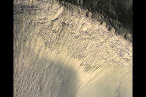 This image from the High Resolution Imaging Science Experiment (HiRISE) camera on NASA's Mars Reconnaissance Orbiter show how the appearance of dark markings on Martian slope changes with the seasons. The marks, called recurrent slope linea, extend down slopes during warmer months and fade away during cooler months. (NASA/JPL-Caltech/Univ. of Arizona)