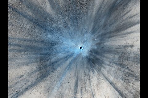 A dramatic, fresh impact crater dominates this image taken by the High Resolution Imaging Science Experiment (HiRISE) camera on NASA's Mars Reconnaissance Orbiter on Nov. 19, 2013. Researchers used HiRISE to examine this site because the orbiter's Context Camera had revealed a change in appearance here between observations in July 2010 and May 2012, bracketing the formation of the crater between those observations. (NASA/JPL-Caltech/Univ. of Arizona)
