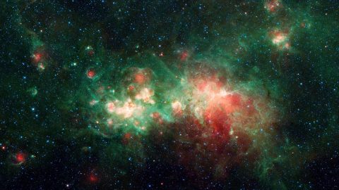 The star-forming nebula W51 is one of the largest "star factories" in the Milky Way galaxy. Interstellar dust blocks the visible light emitted by the region, but it is revealed by NASA's Spitzer Space Telescope, which captures infrared light that can penetrate dust clouds. (NASA/JPL-Caltech)