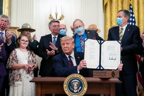 President Donald Trump holds the signed Great American Outdoors Act. (White House)