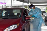 Dr. Julie Gray, Dean of Student Affairs at the Meharry Medical College School of Dentistry, gathers personal information from a patient at the Nissan Stadium drive-thru COVID-19 testing site, Aug. 21, in downtown Nashville. Since early July, the Tennessee National Guard has teamed up with Meharry Medical College to test Tennesseans at the Nissan Stadium site, and has been operating up to 35 mobile testing sites across the state since March. (Staff Sgt. Timothy Cordeiro)