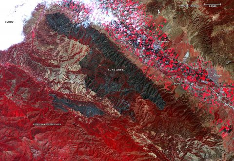 Captured by the ASTER instrument aboard NASA's Terra satellite, this false-color map shows the burn area of the River and Carmel fires in Monterey County, California. Vegetation (including crops) is shown in red; the burn area (dark blue/gray) is in the center of the image. (NASA/METI/AIST/Japan Space Systems)