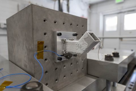 The motor and gearbox are mounted for testing in one of two horizontal orientations. Frost forms on the surface of the “bucket” when liquid nitrogen is used to cool the hardware to the test temperature of -279 degrees Fahrenheit (-173 degrees Celsius). (NASA/JPL-Caltech)