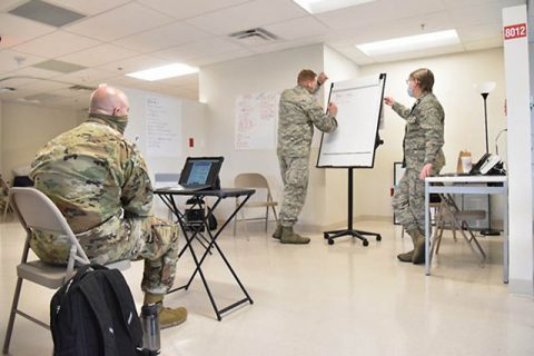 (Left to right) Staff Sgt. Brandon Hill, Maj. William Fitzwater and Lt. Col. Elizabeth Cooper work to establish COVID-19 sanitation procedures at Nashville’s Alternate Care Site, Aug. 27. Cooper, Team Leader for the Infectious Disease Team have been visiting at-risk facilities across the state to improve protocols and procedures to limit the spread of COVID-19. (Staff Sgt. Timothy Cordeiro)