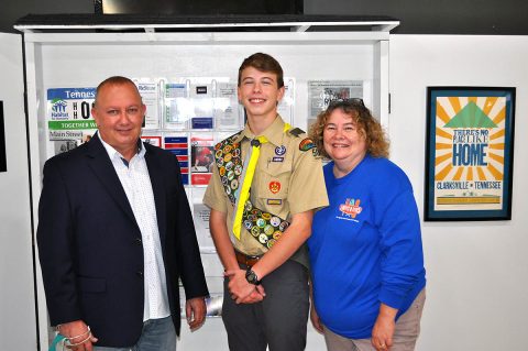 (L to R) HFHMCTN Executive Director Rob Selkow, Eagle Scout Taydan Jackson, and Loaves & Fishes Executive Director Rita Burnett stand in front of the Community Kiosk. (L to R) HFHMCTN Executive Director Rob Selkow, Eagle Scout Taydan Jackson, and Loaves & Fishes Executive Director Rita Burnett stand in front of the Community Kiosk.