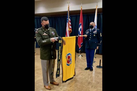 Clemmer places the MacArthur Award streamer on the Austin Peay State University Army ROTC colors, held by Master Sergeant Marcus Gurule, APSU senior military instructor. (APSU)