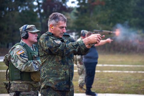 Bulgarian Chief of Defense Adm. Emil Eftimov fires the M-17 handgun, Oct. 8, at a small-arms pop-up range at Volunteer Training Site - Tullahoma. Bulgarian officials visited the Tennessee National Guard after signing a new training roadmap with the U.S., renewing their partnership through 2030. (Staff Sgt. Timothy Cordeiro, Tennessee National Guard Public Affairs Office)