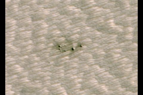 The HiRISE camera aboard NASA's Mars Reconnaissance Orbiter took this image of a crater cluster on Mars, the first ever to be discovered AI. The AI first spotted the craters in images taken the orbiter's Context Camera; scientists followed up with this HiRISE image to confirm the craters. (NASA/JPL-Caltech/University of Arizona) The HiRISE camera aboard NASA's Mars Reconnaissance Orbiter took this image of a crater cluster on Mars, the first ever to be discovered AI. The AI first spotted the craters in images taken the orbiter's Context Camera; scientists followed up with this HiRISE image to confirm the craters. (NASA/JPL-Caltech/University of Arizona)