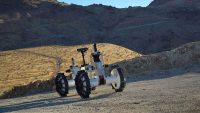 The DuAxel rover is seen here participating in field tests in the Mojave Desert. The four-wheeled rover is composed of two Axel robots. One part anchors itself in place while the other uses a tether to explore otherwise inaccessible terrain. (NASA/JPL-Caltech/J.D. Gammell)