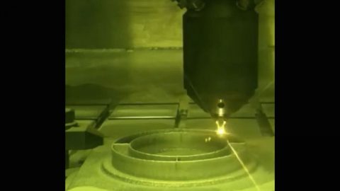 This photo shows a 3D printing technique where a printer head scans over each layer of a part, blowing metal powder which is melted by a laser. It's one of several ways parts are 3D printed at NASA's Jet Propulsion Laboratory, but was not used to create the parts aboard the Perseverance rover. (NASA/JPL-Caltech)