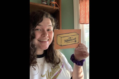 Austin Peay State University student Victoria Bolkcom poses with a wooden postcard she recently received from Hero Seto, a graduate. (APSU) Austin Peay State University student Victoria Bolkcom poses with a wooden postcard she recently received from Hero Seto, a graduate. (APSU)