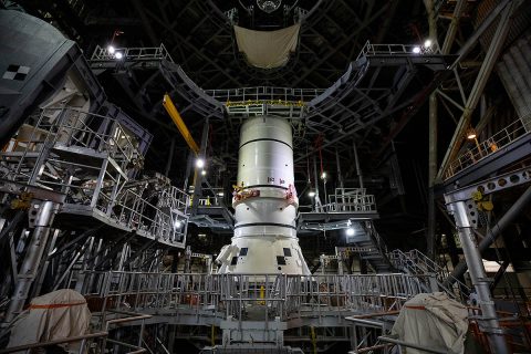 The aft segments of the Space Launch System solid rocket boosters for the Artemis I mission prepare to move from high bay 4 inside the Vehicle Assembly Building for stacking on the mobile launcher inside high bay 3 at Kennedy Space Center in Florida. (NASA/Cory Huston)