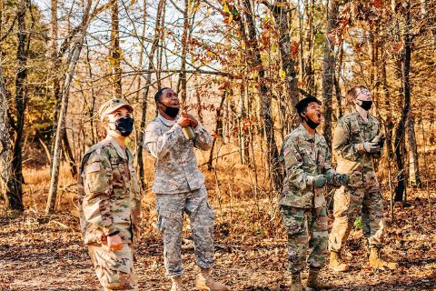 Austin Peay State University senior cadet Chantal Alequin and three underclassmen cadets cheer another Army ROTC cadet on at the Sabalauski Air Assault School obstacle course. (APSU)