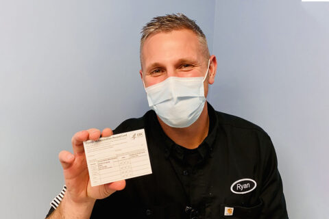 Registered nurse, Mr. Ryan Diehl, a frontline healthcare worker assigned to Blanchfield Army Community Hospital’s Emergency Center, shows his COVID-19 Vaccination Record Card before adding his personal information. He and other healthcare workers and first responders are among the first recipients of the first phase of COVID vaccines on Fort Campbell. (U.S. Army photo by Maria Yager)