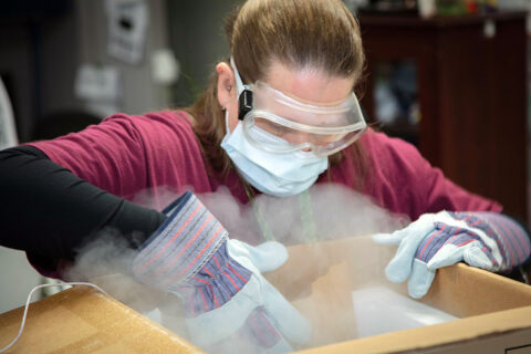 In a cautiously synchronized operation, Pharmacy Supply Supervisor Jennifer Clark races against the clock to transfer Blanchfield Army Community Hospital’s initial shipment of the COVID-19 vaccine from container to freezer. The hospital began inoculating healthcare workers and first responders, marking the start of its phased-in vaccination program to mitigate the spread of the virus. (U.S. Army photo by David E. Gillespie)