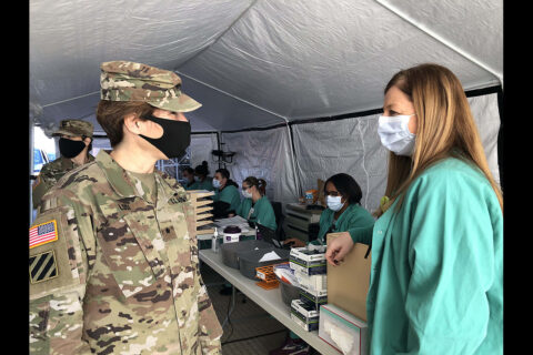 Regional Health Command-Atlantic Commanding General Brig. Gen. Paula Lodi speaks with Blanchfield Army Community Hospital frontline healthcare worker Ms. Candy Hampton in the hospital’s drive-thru COVID-19 testing center, Jan. 4. Lodi shared her appreciation with Hampton and other BACH staff who support the hospital’s COVID-response mission. (U.S. Army photo by Laura Boyd.)