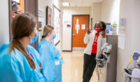 Nursing students listen to instruction after a simulation. (APSU)