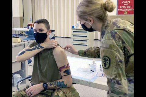 BACH Soldier Spc. Ireland Case prepares to give a COVID-19 vaccine to Spc. Travis Evans from the 1st Battalion, 26th Infantry Regiment, 2nd Brigade Combat Team, 101st Airborne Division – “Blue Spaders”  at the COVID-19 Vaccine Clinic located in the Fort Campbell Passenger Processing Center, March 5. (U.S. Army photo by Maria Yager)