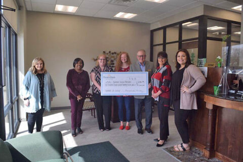 Customs House Museum receives check at Planters Bank's Hilldale Branch.