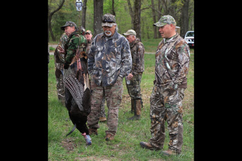 Members of the turkey hunt observe the winning turkey as it is weight during the annual turkey hunt hosted by the Military Officers Association of America here April 17th, 2021. (Sgt. 1st Class Jacob Connor, 101st Airborne Division)