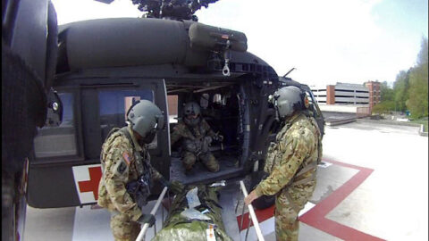 The patient is offloaded at the UT Medical Center helipad by Tennessee National Guard’s Col. Robert Ross (left), Staff Sgt. Donald Sweet (center), and Sgt. 1st Class Giovanni DeZuani (right) after a search and rescue mission along the Appalachian Trails, April 15th. (Tennessee National Guard)