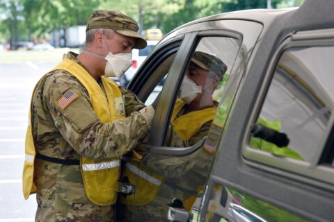 Sgt. Zack Vredenburgh, from Clarksville, administers a COVID-19 vaccine at the drive-thru testing and vaccination center at Volunteer State Community College, May 13th, in Gallatin. (1st Class William Jones, Tennessee National Guard Public Affairs Office)