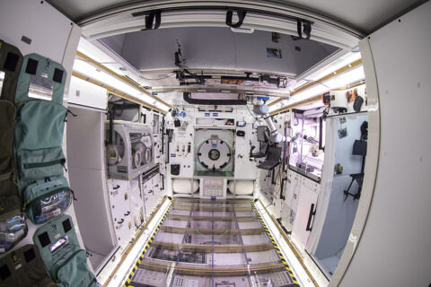 Ahead of future lunar missions, NASA wanted a sensor to warn inhabitants if the level of dust gets dangerous. Lunar Outpost Inc. developed the Space Canary, an air-quality sensor, shown here (cannister-shaped device above the open door on the right) in a lunar habitat prototype designed by Lockheed Martin. (Lockheed Martin Corporation)