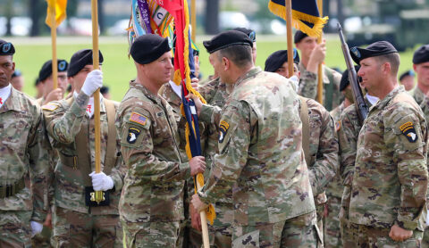 Maj. Gen. J.P. McGee, commander of the 101st Airborne Division (Air Assault), passes the brigade colours to Col. Mark Federovich, the incoming commander of the 3rd Brigade Combat Team, 101st Airborne Division (Air Assault), during a change of command ceremony on Fort Campbell, KY June 18th, 2021. (Staff Sgt. Michael Eaddy) 