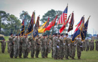 Unit commanders and colour bearers salute during a change of command ceremony for the 3rd Brigade Combat Team, 101st Airborne Division (Air Assault), on Fort Campbell, KY June 18th, 2021. The unit colours is passed during a ceremony which symbolizes the transfer of command responsibility and authority from the old commander to the new commander. (Staff Sgt. Michael Eaddy)