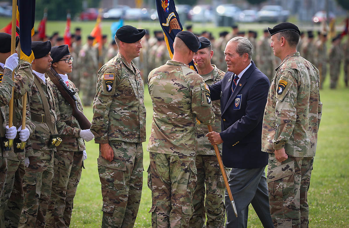 Col. Mark Federovich, incoming commander of the 3rd Brigade Combat Team, 101st Airborne Division (Air Assault), receives the regimental colours from Command Sgt. Maj. (Retired) Gerald Counts, the Honorary Colonel of the 187th Infantry Regiment, during a change of command ceremony on Fort Campbell, KY June 18, 2021. (Staff Sgt. Michael Eaddy)
