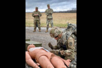 Blanchfield Army Community Hospital Command Team Command Sgt. Maj. Daniel Santiago and Col. Patrick T. Birchfield observed as BACH Soldier Staff Sgt. Derrick Hise stabilized his patient and prepared to call in a medical evacuation during a combat casualty care exercise. (U.S. Army)