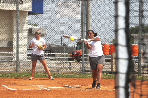 At bat is Sgt. Summer Allen 3rd Recruiting Brigade, Knoxville, Tenn., while Sgt. Samantha Baker, 7th Special Forces Group, Fort Bragg, N.C., catches behind the plate July 23 at Fort Campbell. Tryouts started July 22 and will continue through Aug. 2 when coaching staff makes the final cut. (Sirena Clark, Fort Campbell Public Affairs Office)