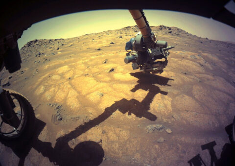 The robotic arm on NASA’s Perseverance rover reached out to examine rocks in an area on Mars nicknamed the “Cratered Floor Fractured Rough” area in this image captured on July 10th, 2021 (the 138th sol, or Martian day, of its mission). (NASA/JPL-Caltech)