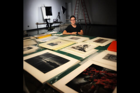 Austin Peay State University art student Katie Boyer with some of the photos she's working with this summer. (APSU)